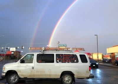 R Miller's Electrical van with rainbow